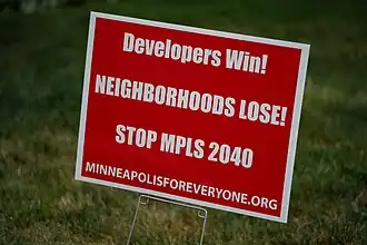 A lawn sign reads, "Developers Win, Neighborhoods Lose! Stop MPLS 2040"