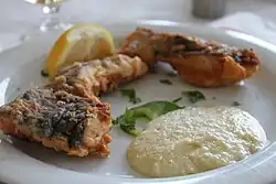 Salted cod with garlic sauce, a traditional Greek dish for the day of the Annunciation,[15] served at a Greek restaurant