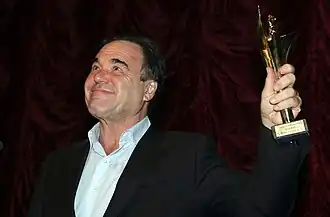 Oliver Stone with Golden Alexander in hand