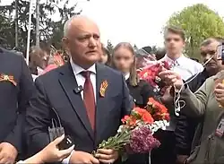 Moldovan former president Igor Dodon (wearing the Ribbon of Saint George) with members of the Șor Party at a Victory Day rally in Moldova on 9 May 2023