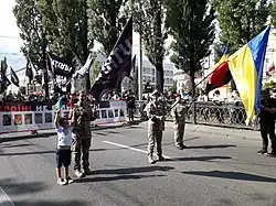 Yulia Mykytenko leads the "Female veterans movement" column at the unofficial ("volunteer") military parade for the Independence Day of Ukraine on August 24, 2021 (in the middle).