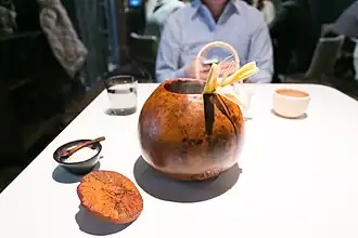 Baby corn served in a hollow gourd with salt for seasoning.