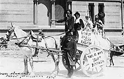 This is a photograph of students on horse cart taking part in the annual Prosh event IN 1905, poking fun at Nobel Prize laureates Bragg and Bragg. A poster reads "Do not Bragg about radium".