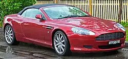 Front three-quarters view of a red DB9 Volante convertible