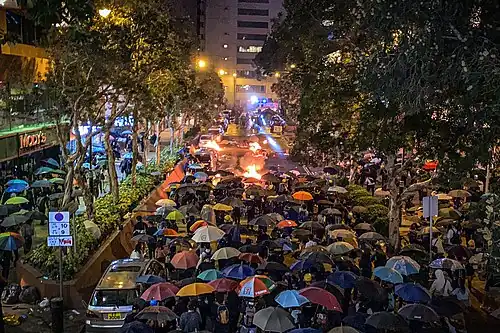 Protesters trying to break police cordon in Tsim Sha Tsui to get near the campus