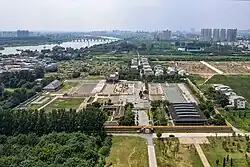 Ruins of Yanshi Shang City with the skyline of Yanshi District in the background