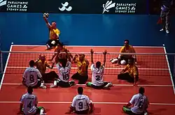 People playing sitting volleyball