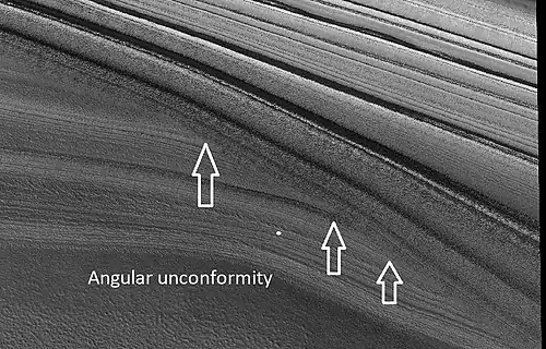Close view of layers in northern ice cap, as seen by HiRISE under HiWish program Arrows point to an angular unconformity.