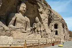 Buddhist statues carved in a stone cliff