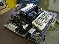 Paper tape punch and reader visible in foreground