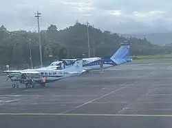Trigana Air ATR 42-300 and Cessna 208B parked at Ambon Airport
