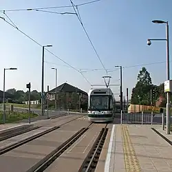 The stop looking south, with the crossing of Ruddington Lane
