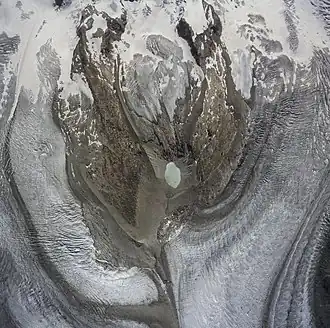 Aerial photo of Monte Rosa massif with Gornergletscher on the left and Grenzgletscher on the right. The green spot in the middle is the glacier lake Gornersee (2.599 m)[11]
