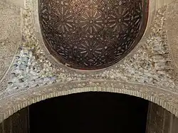 Ceiling of the hall: a rounded wooden vault, transitioning through muqarnas to the arch of the side alcove