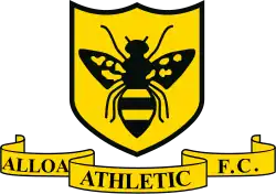 A logo depicting a gold shield with black edges and a black wasp on it. Below the shield, the words "Alloa Athletic F.C." appear on a gold scroll banner.