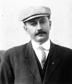 Portrait of Alvin Kraenzlein standing, shown from about the chest while facing the camera.