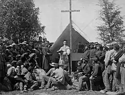 Sunday morning mass in camp of 69th N.Y.S.M. Photograph shows Father Thomas H. Mooney, Chaplain of the 69th Infantry Regiment of the New York State Militia and Irish American soldiers at a Catholic Mass at Fort Cocoran, Arlington Heights, Virginia on June 1, 1861. (Source: The Irish American, June 22, 1861)