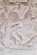 Knee strike at a distracted opponent. Bas-relief from a mural at Angkor Wat.