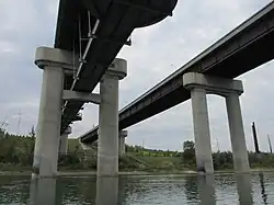 Anthony Henday Drive bridges over the North Saskatchewan River in southwest Edmonton, Alberta. The eastbound bridge includes a pedestrian walkway underneath the bridge.
