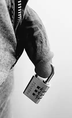 Lock inserted through a piercing in a penis