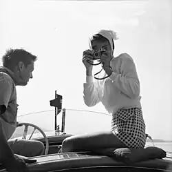 Hepburn wearing a sweater with cropped gingham shorts, c. 1954