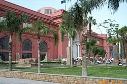 Exterior view of the museum showing its distinctive pinkish-beige colored neoclassical facade