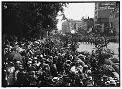 A black and white photograph of a big group of people watching the dedication ceremony parade