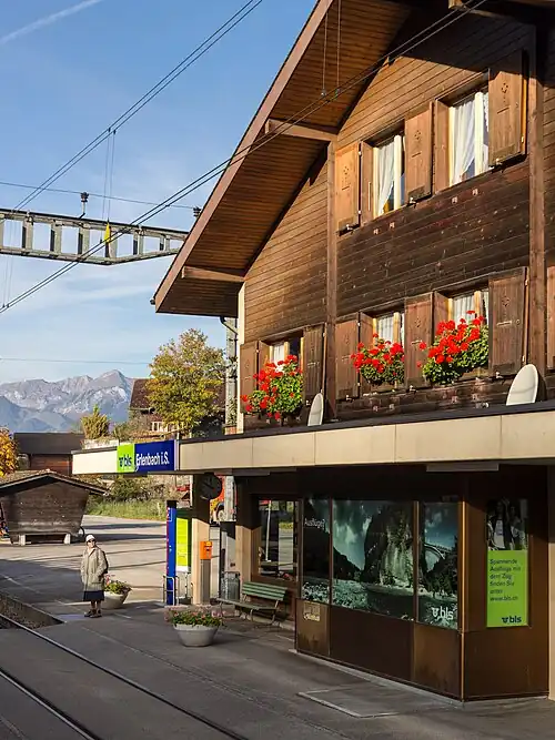 Three-story wooden building with gabled roof