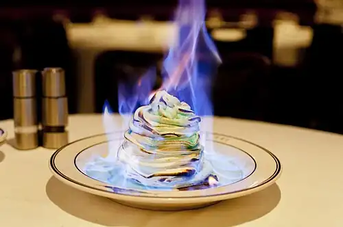 A bombe Alaska which has been flambéed with alcohol at a restaurant