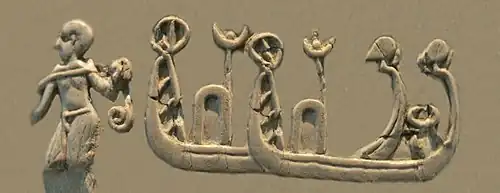 Shaven-headed man towing high-prowed boats, of a type seen on Sumerian Uruk period seals and artworks.[9] Possibly part of the depiction of a naval battle.[10][11][12] (Front, 3rd register)