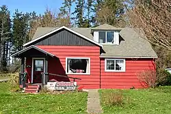 A red building with a sign that says "Chinook Tribal Office"
