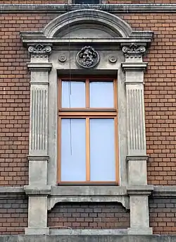 Window with pilasters, pediment and mascaron