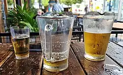 photo of jugs of beer at a bar