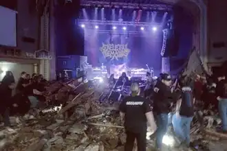 Concertgoers attempt to remove debris atop audience members