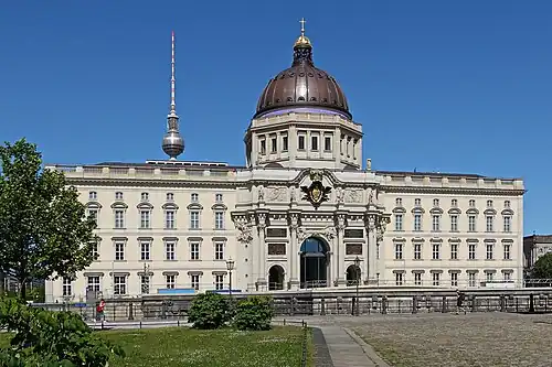 The palace with the reconstructed bronze reliefs and plaques on the portal initially designed by the architect Eosander[b]
