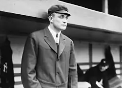 Photograph of Billy Evans standing in a dugout