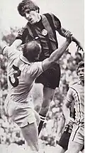 This is Billy during the game against Coventry City where he leaps above Jim Brogan to win the ball.