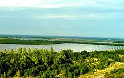 Image 82Part of the Senftenberg Solarpark, a solar photovoltaic power plant located on former open-pit mining areas close to the city of Senftenberg, in Eastern Germany. The 78 MW Phase 1 of the plant was completed within three months. (from Solar power)