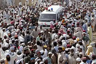 Pakistanis surround an ambulance carrying the body of rebel cleric Abdul Rashid Ghazi during his funeral in Basti Abdullah, Pakistan.