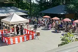 a coutyard with people watching a musical performance