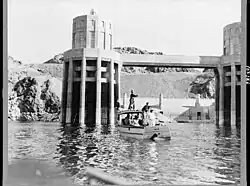 Fisherman trying their luck alongside the Arizona intake towers of Boulder Dam, March 1939
