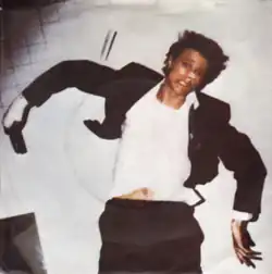 A man lying on the floor, his face shell-shocked with a bandage on his nose. His arms vault outwards in arches.