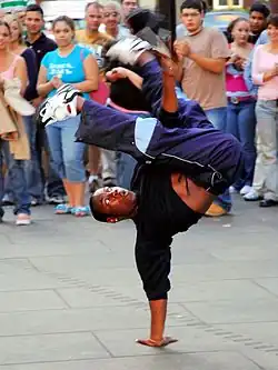 Street dance – a Breakdancer performs a handstand trick.