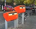 A Dutch &quot;Post-NL&quot; postbox in orange at different heights