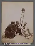 Two Persian peasants and two Persian officers gambling, between 1876 and 1933; the standing peasant is wearing a papakha. Brooklyn Museum