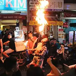 A woman doing fire breathing on the street