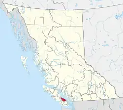 A map of British Columbia depicting its 29 regional districts and equivalent municipalities. One is highlighted in red.
