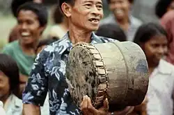 Musician playing tifa drum during tug-of-war matches at Ullath.