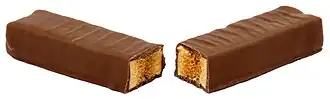 A Crunchie chocolate bar split open to reveal the honeycomb toffee inside