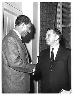 Carl Albert shaking hands with Anwar Sadat